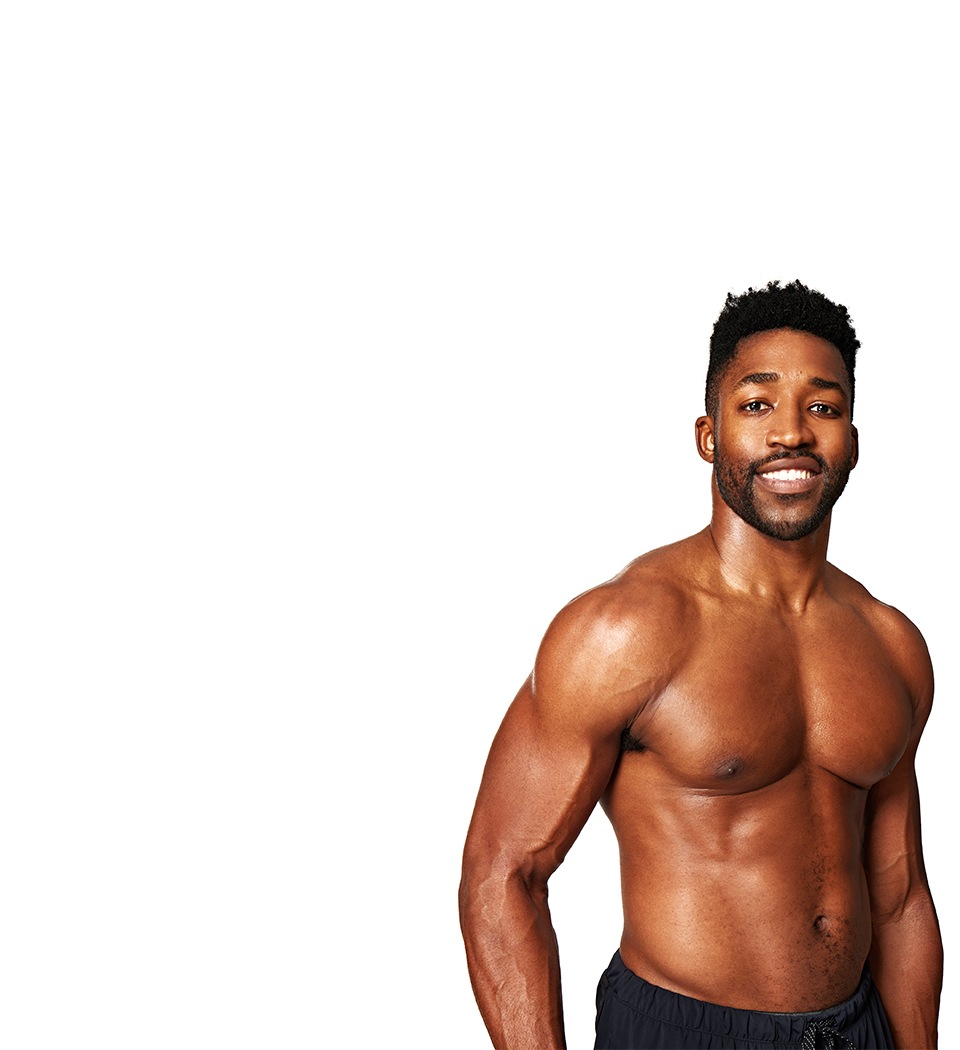 Barry’s instructor shirtless standing confidently smiling against a white background