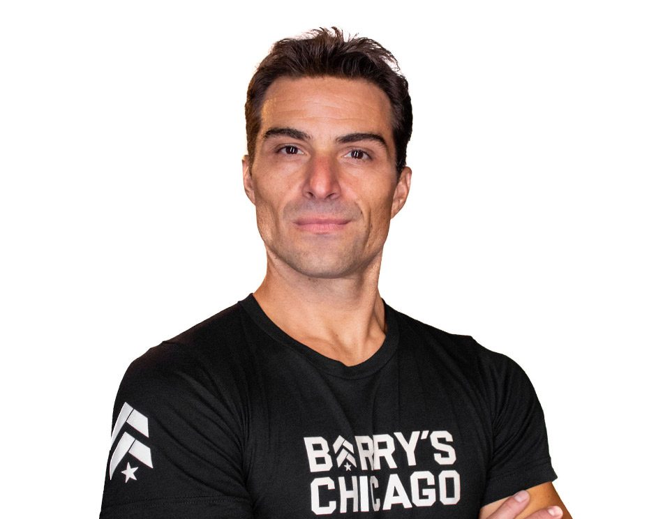 Barry's instructor standing confidently wearing a black top against a white background.