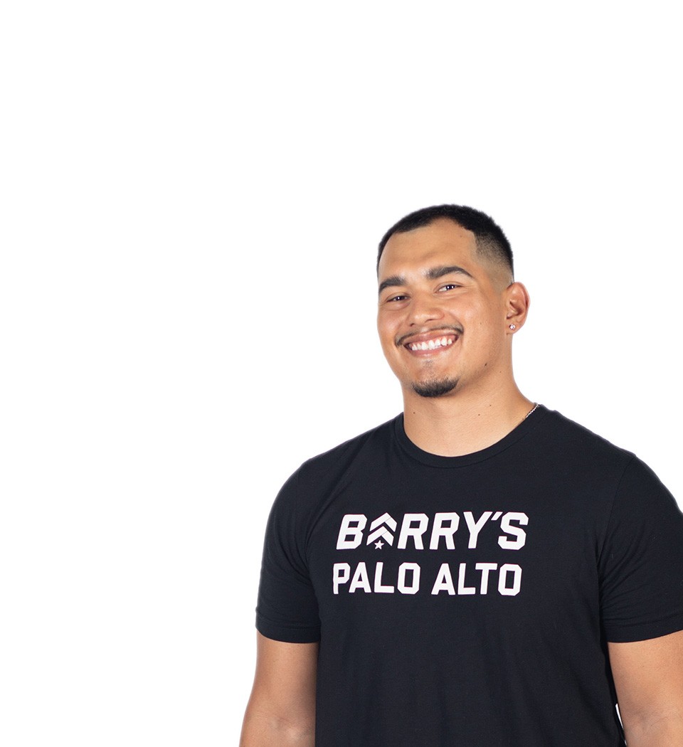 Barry's instructor standing confidently wearing a black top against a white background.