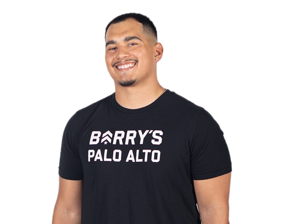 Barry's instructor standing confidently wearing a black top against a white background.