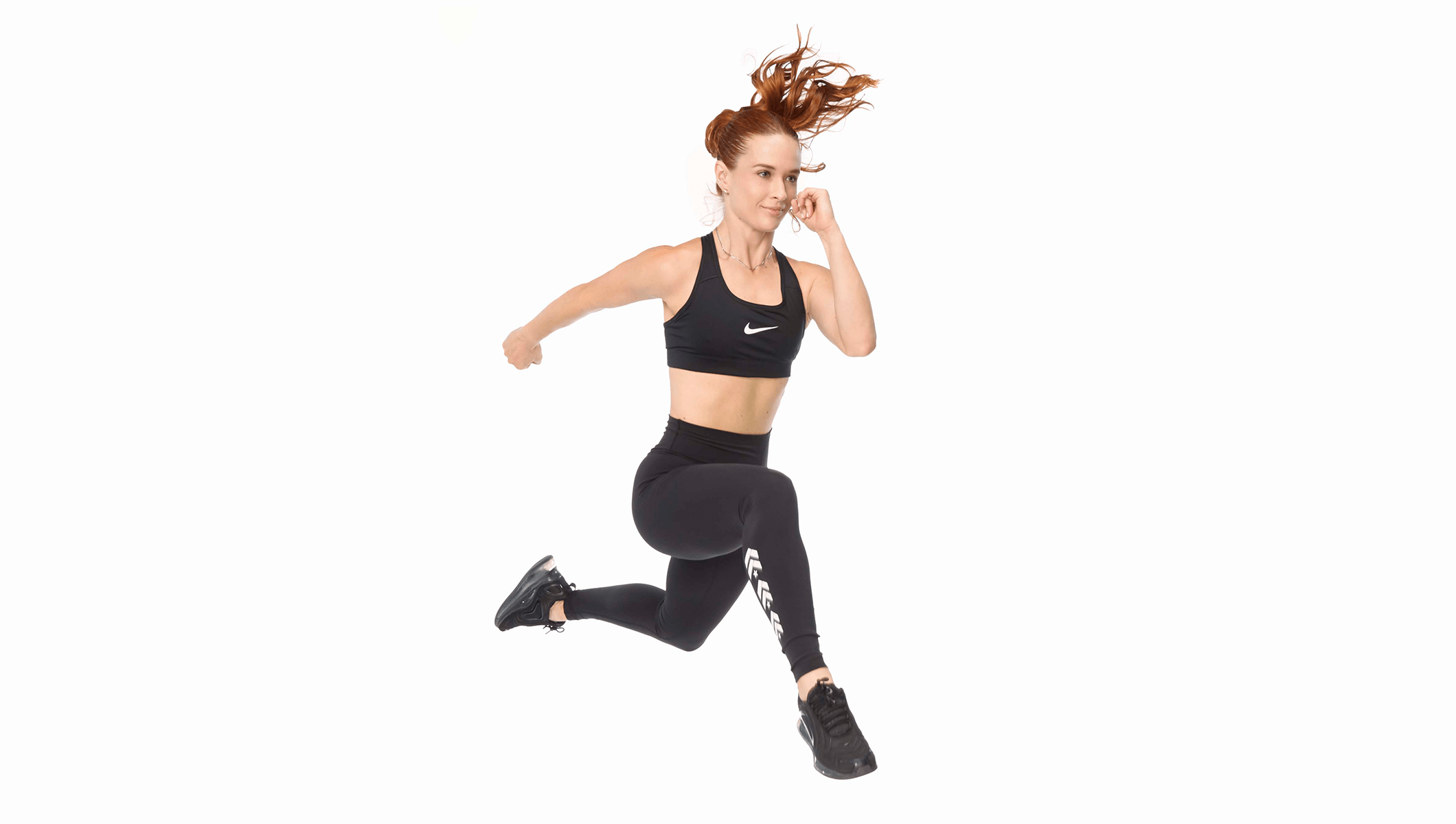 Barry's instructor running wearing a black top against a white background.