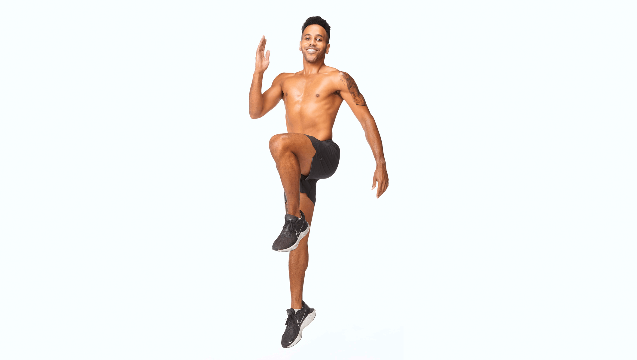 Barry's instructor jumping wearing a black shorts against a white background.