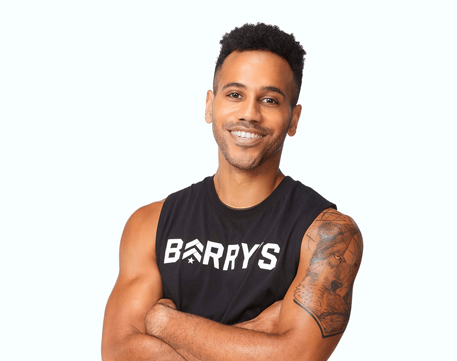 Barry's instructor standing confidently wearing a black top against a white background.