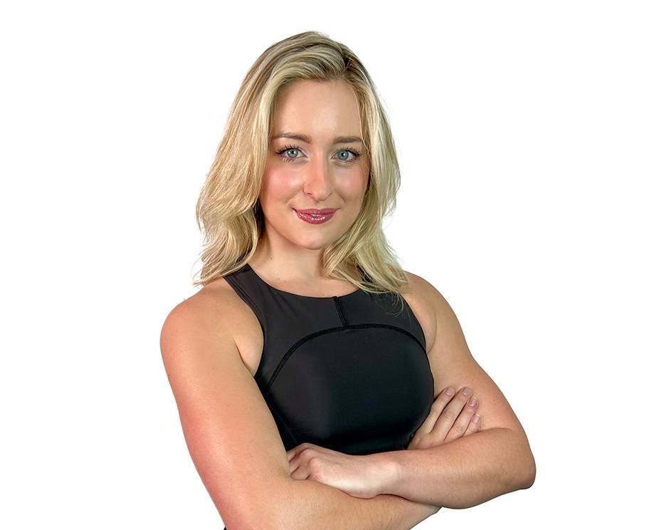 Barry's instructor standing confidently wearing a black top against a white background.