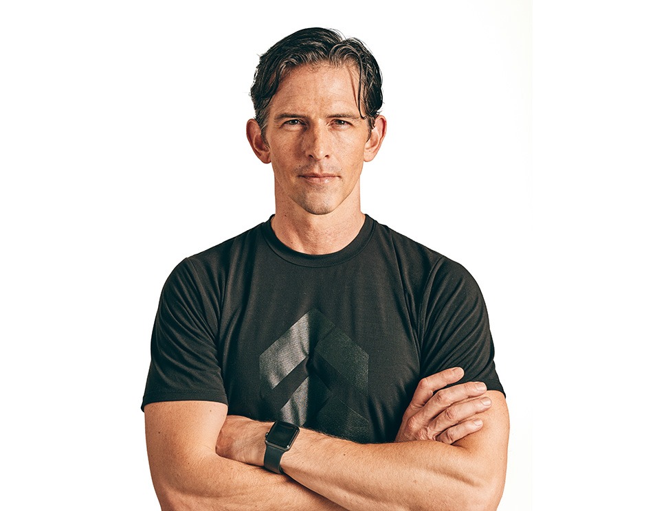 Barry's instructor standing confidently wearing a black top against a white background.