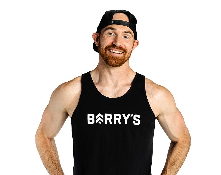 Barry's instructor standing confidently wearing a black top against a white background.