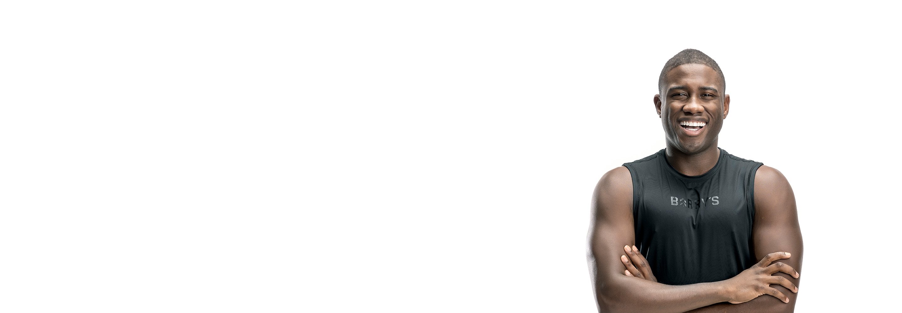 Barry's instructor standing confidently wearing a black top against a white background.