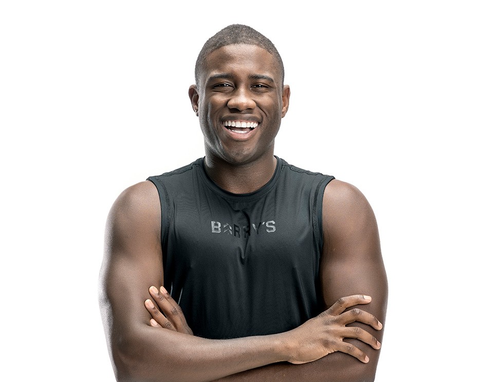 Barry's instructor standing confidently wearing a black top against a white background.