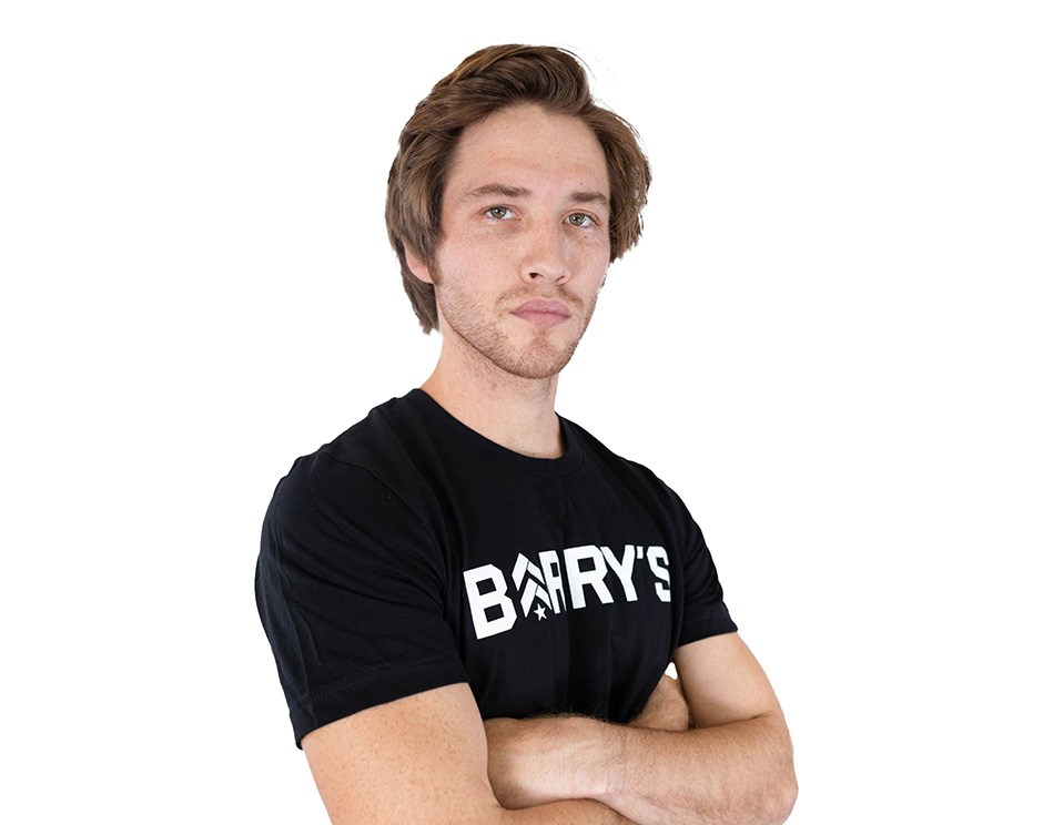 Barry's instructor standing confidently wearing a black top against a white background.