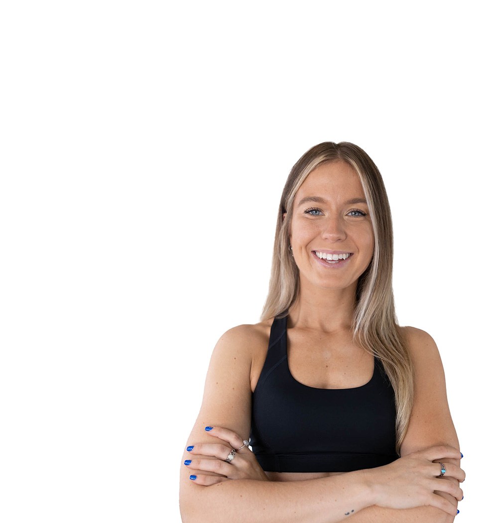 Barrys instruktör står självsäkert klädd i en svart topp mot en vit bakgrund.