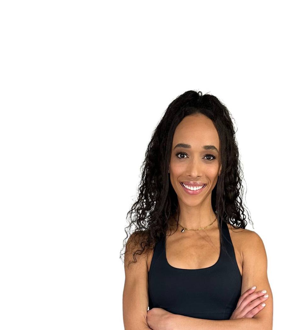 Barry's instructor standing confidently with arms crossed wearing a black top against a white background.
