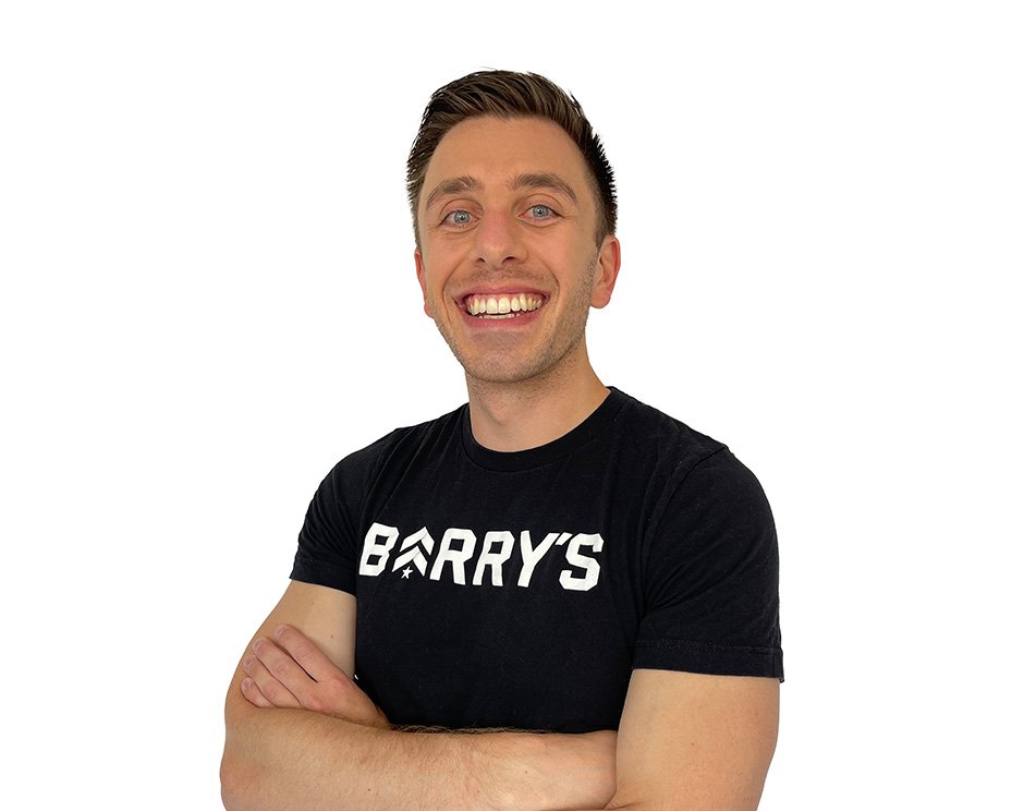 Barry's instructor standing confidently wearing a black top against a white background.