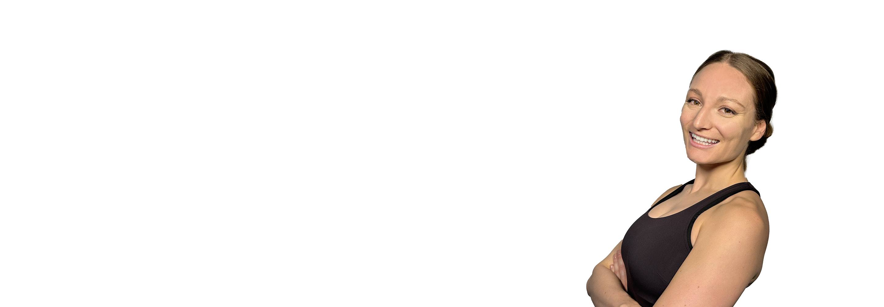 Barry's instructor standing confidently with arms crossed wearing a black top against a white background.