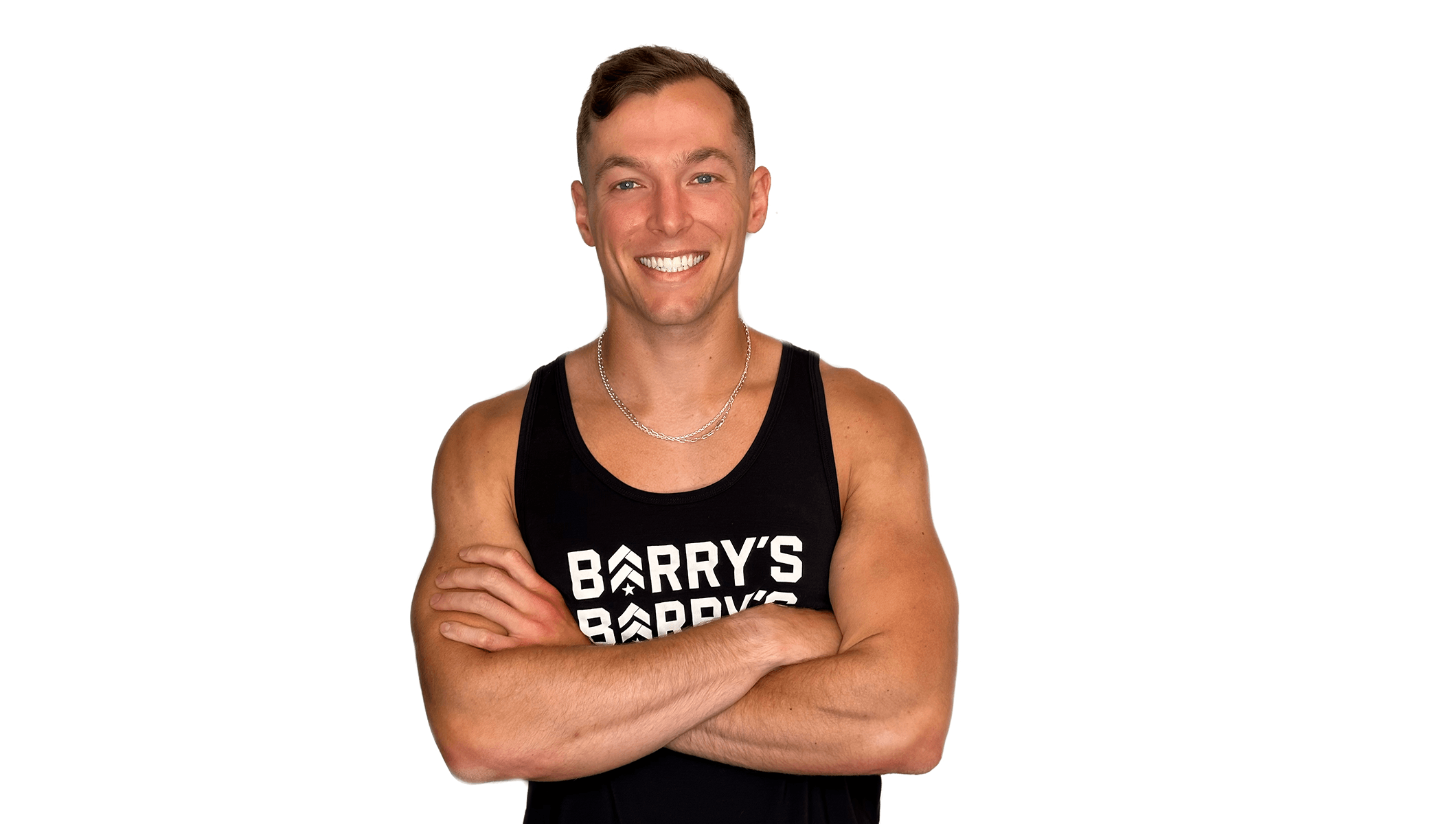 Barry’s instructor wearing a black top standing confidently smiling against a white background