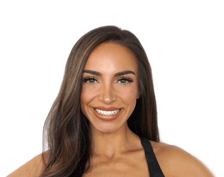 Barry’s instructor wearing a black top standing confidently smiling against a white background