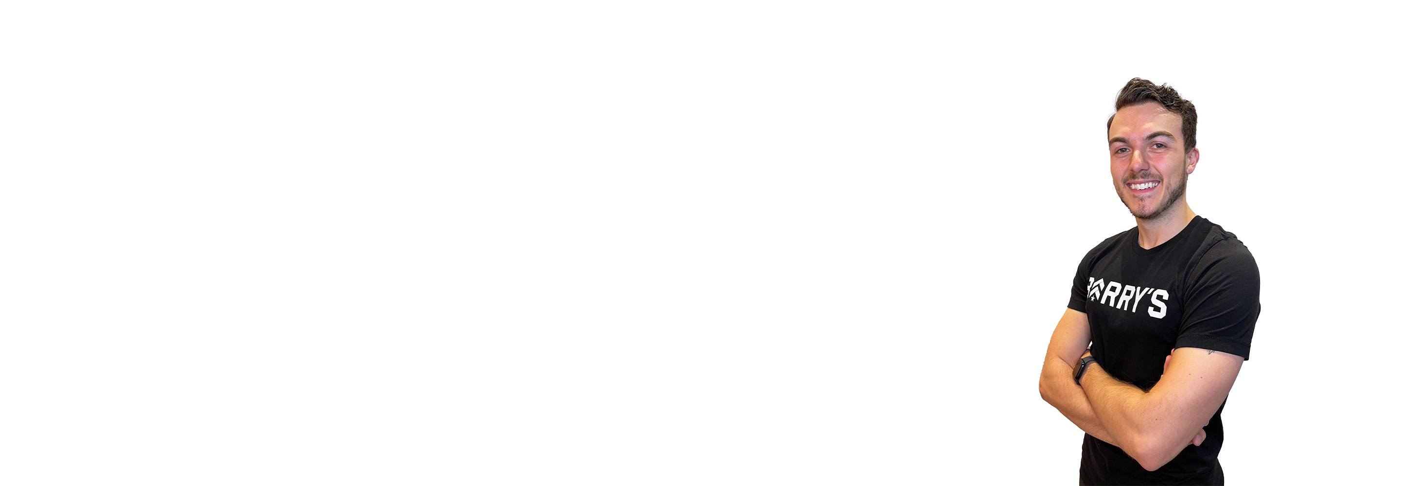 Barry's instructor standing confidently with arms crossed wearing a black top against a white background.