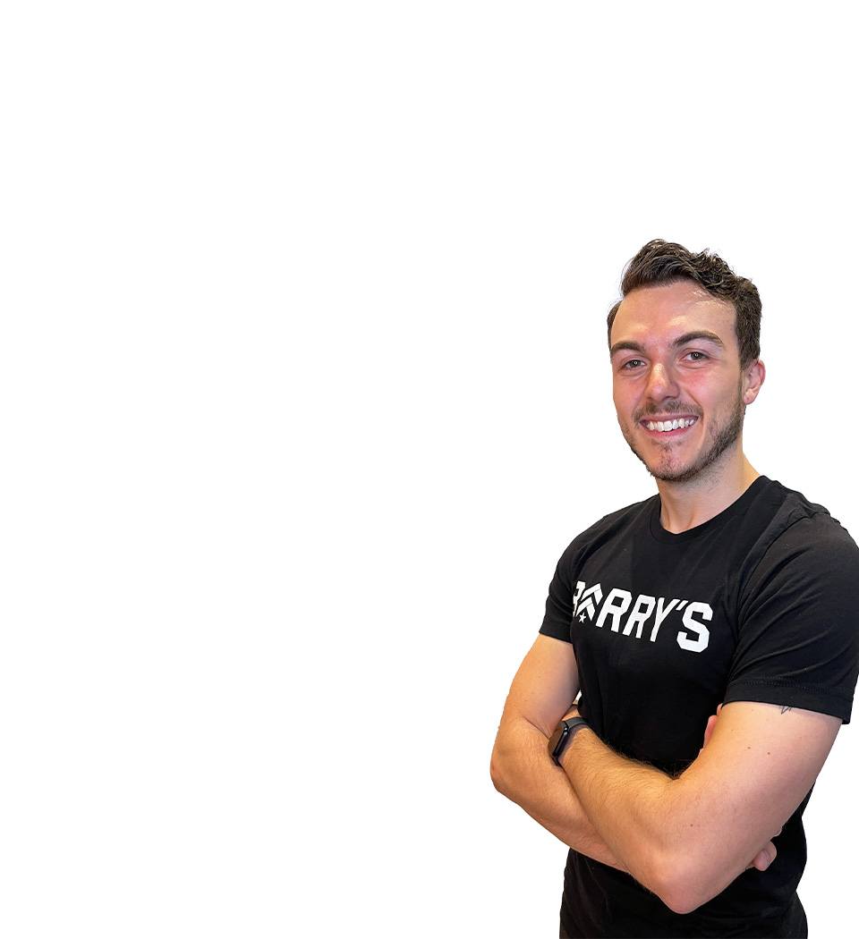 Barry's instructor standing confidently with arms crossed wearing a black top against a white background.