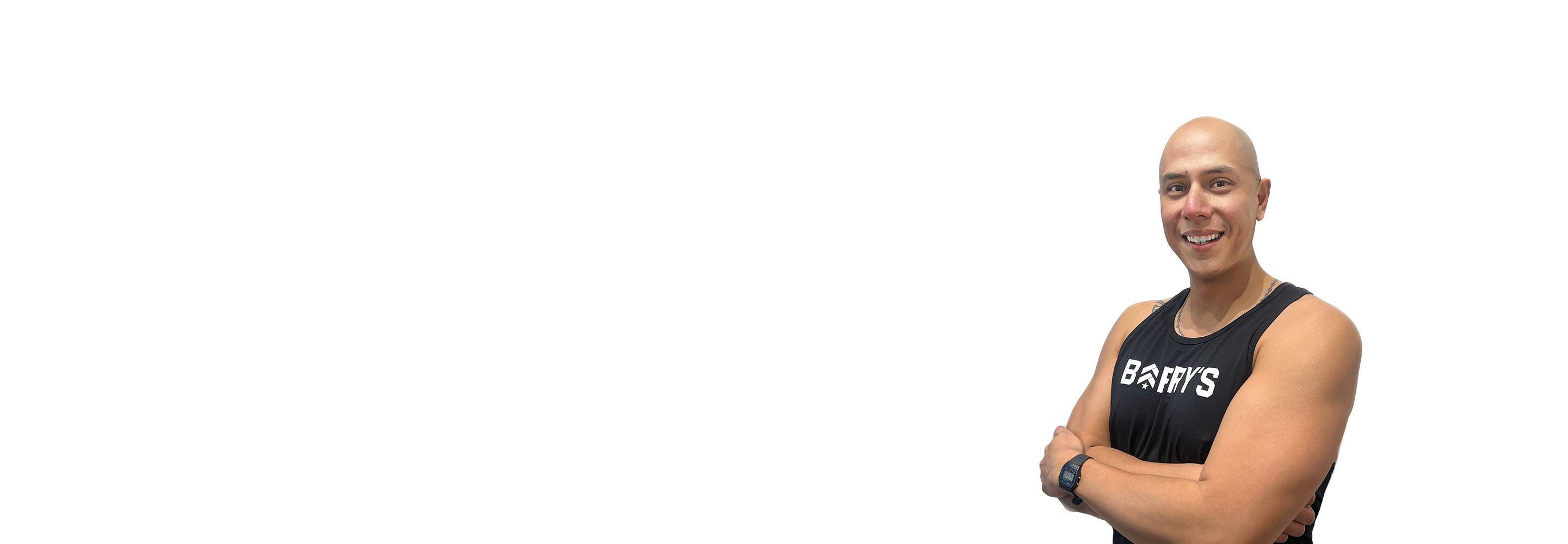 Barry's instructor standing confidently wearing a black top against a white background.