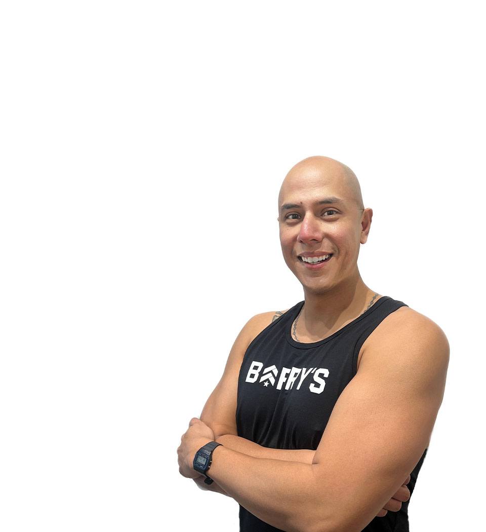 Barry's instructor standing confidently wearing a black top against a white background.