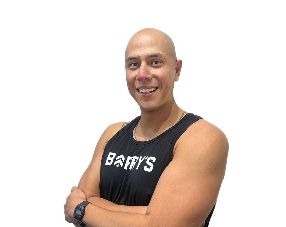 Barry's instructor standing confidently wearing a black top against a white background.