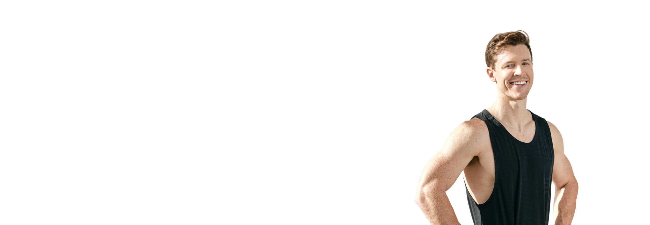 Barry’s instructor wearing a black top standing confidently smiling against a white background