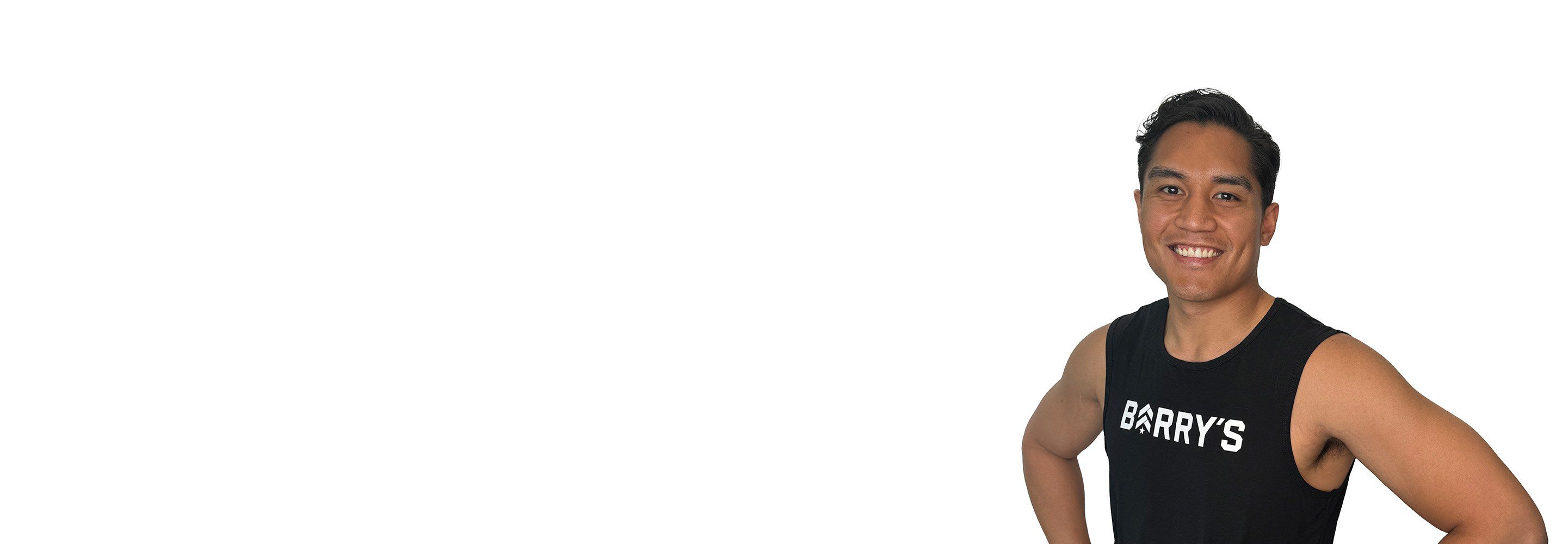 Barry's instructor standing confidently wearing a black top against a white background.