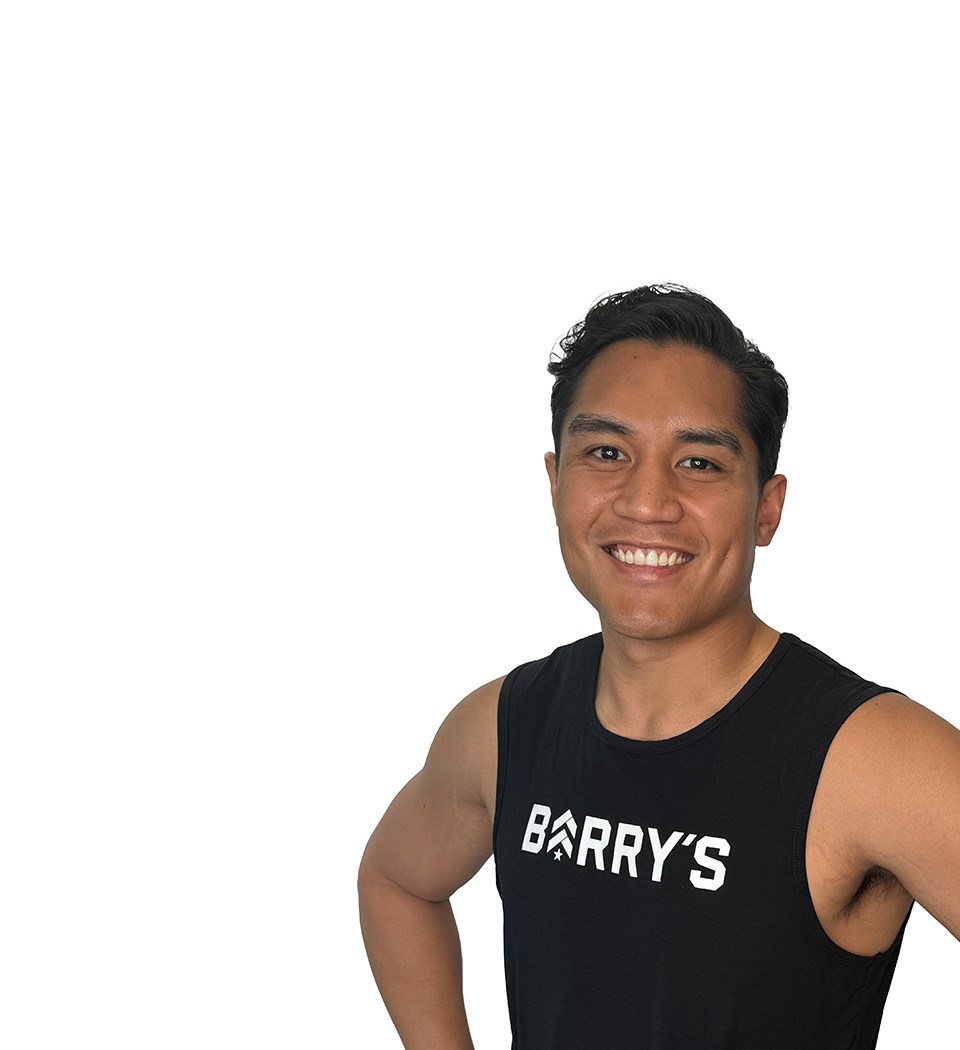 Barry's instructor standing confidently wearing a black top against a white background.