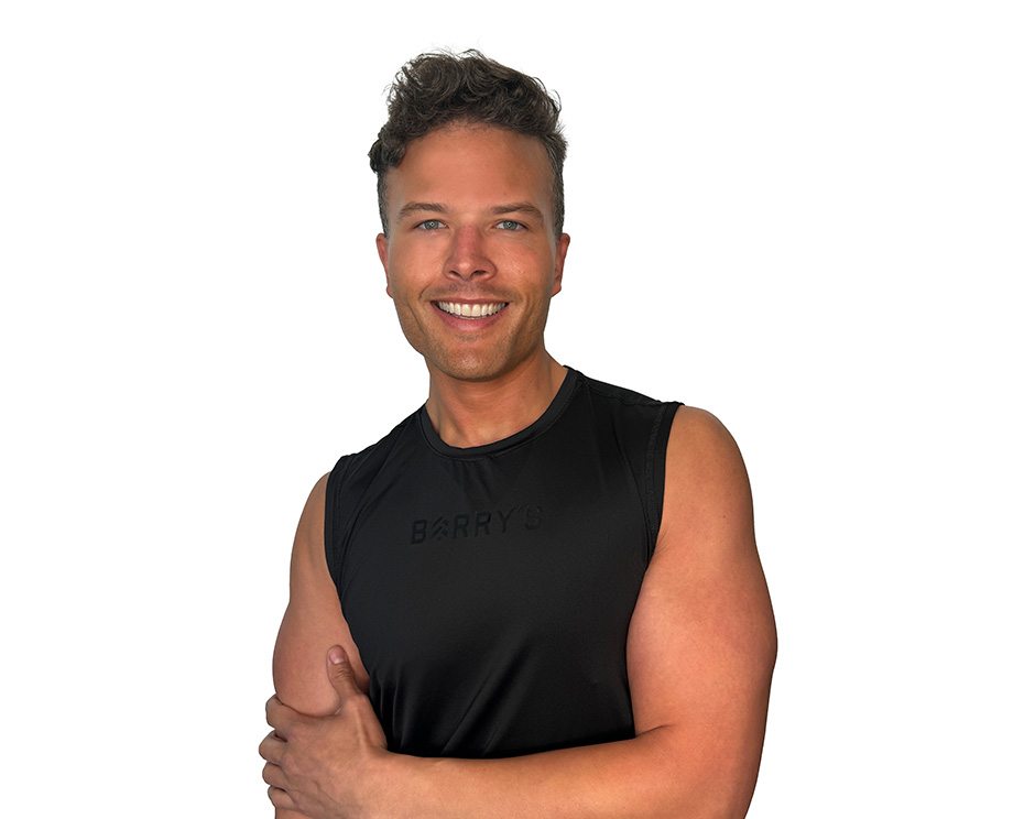 Barry's instructor standing confidently wearing a black top against a white background.