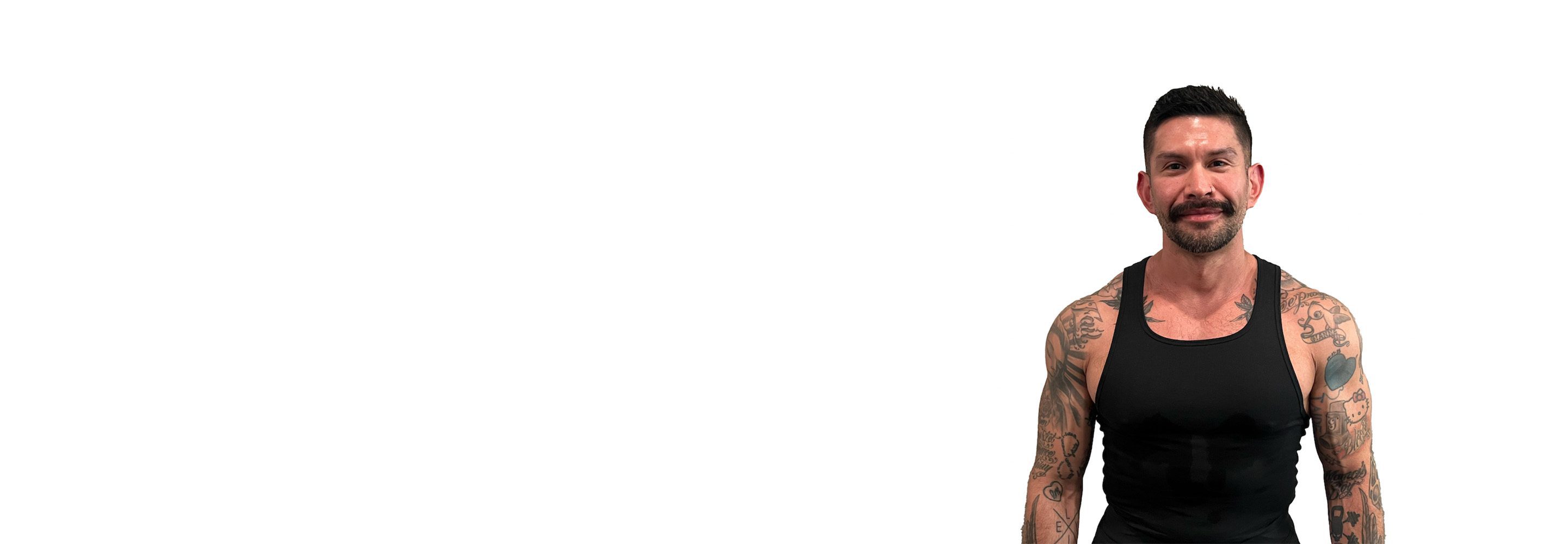 Barry's instructor standing confidently wearing a black top against a white background.