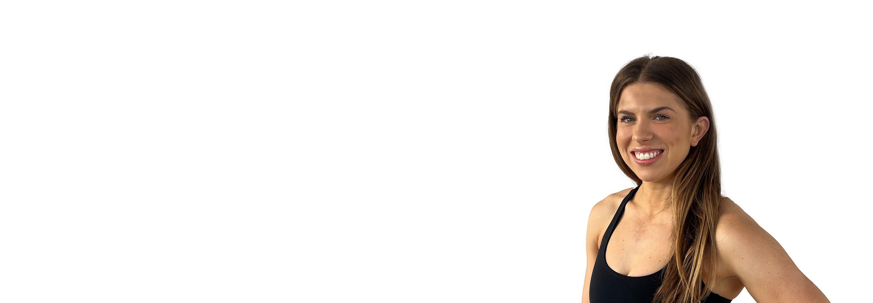 Barry's instructor standing confidently, wearing a black tank top against a white background, ready for the next workout challenge.