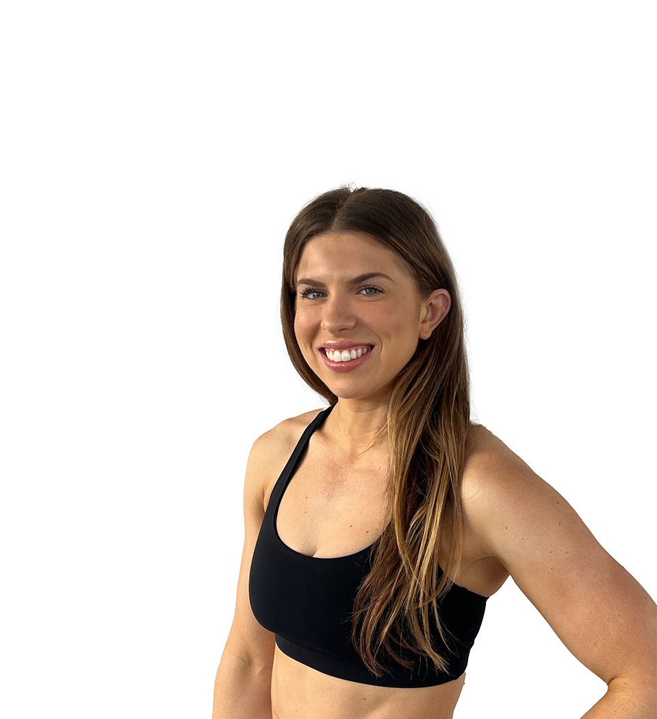 Barry's instructor standing confidently, wearing a black tank top against a white background, ready for the next workout challenge.