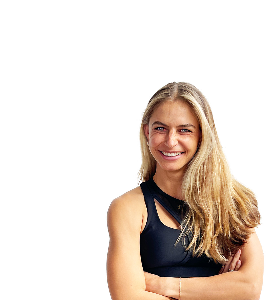 Barry's instructor standing confidently with arms crossed wearing a black top against a white background.