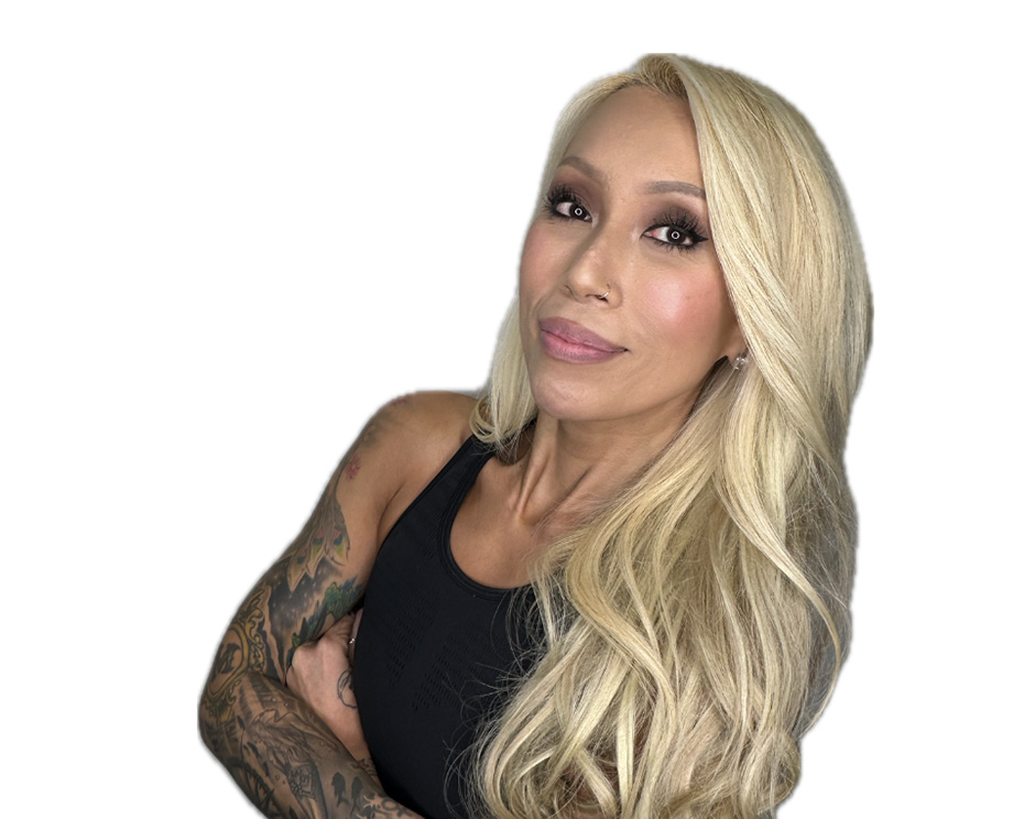 Barry’s instructor wearing a black top standing confidently smiling against a white background