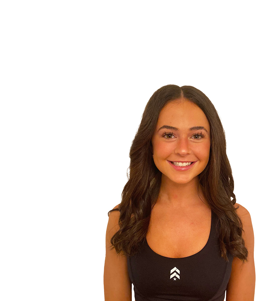 Kiley C. Barry's instructor standing confidently wearing a black top against a white background.