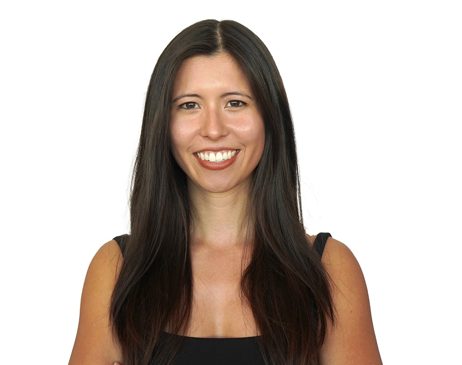 Barry's instructor standing confidently with arms crossed in front, wearing a black tank top against a white background, ready for the next workout challenge.
