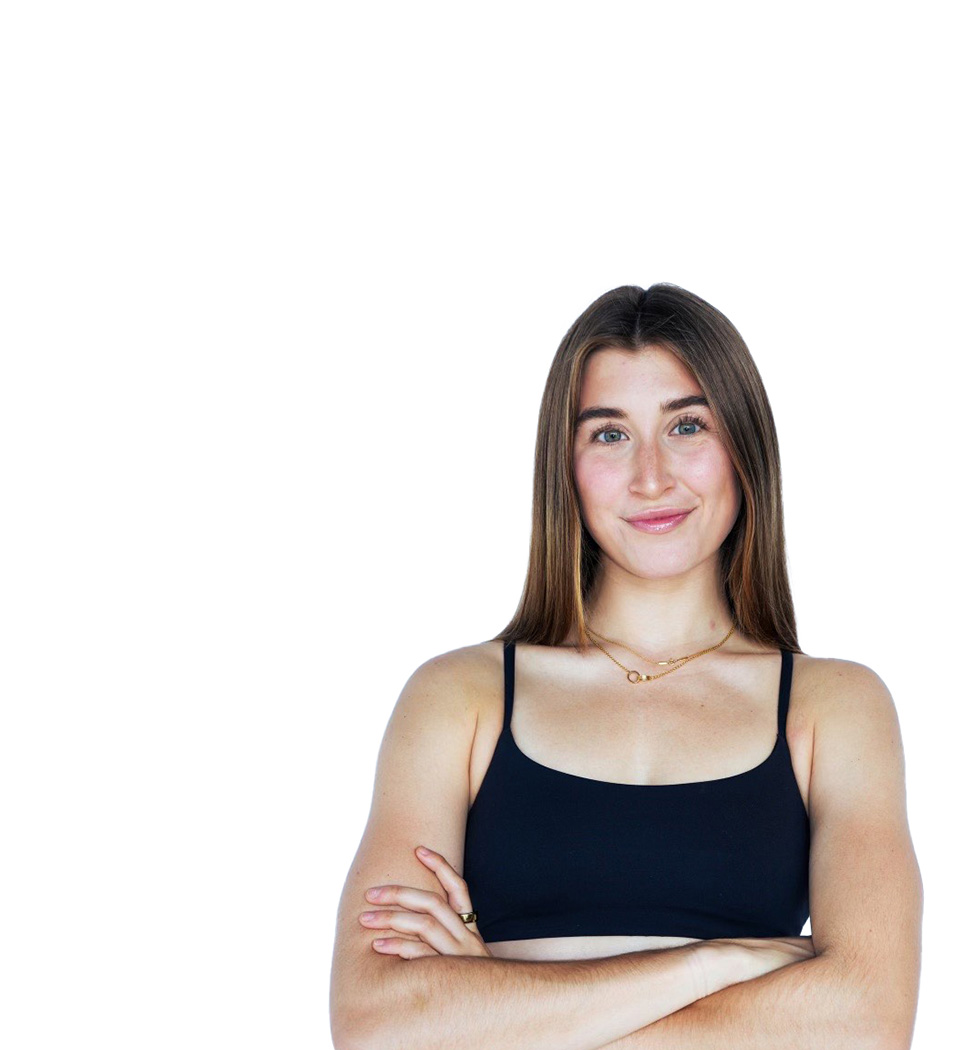 Barry’s instructor wearing a black top standing confidently smiling against a white background