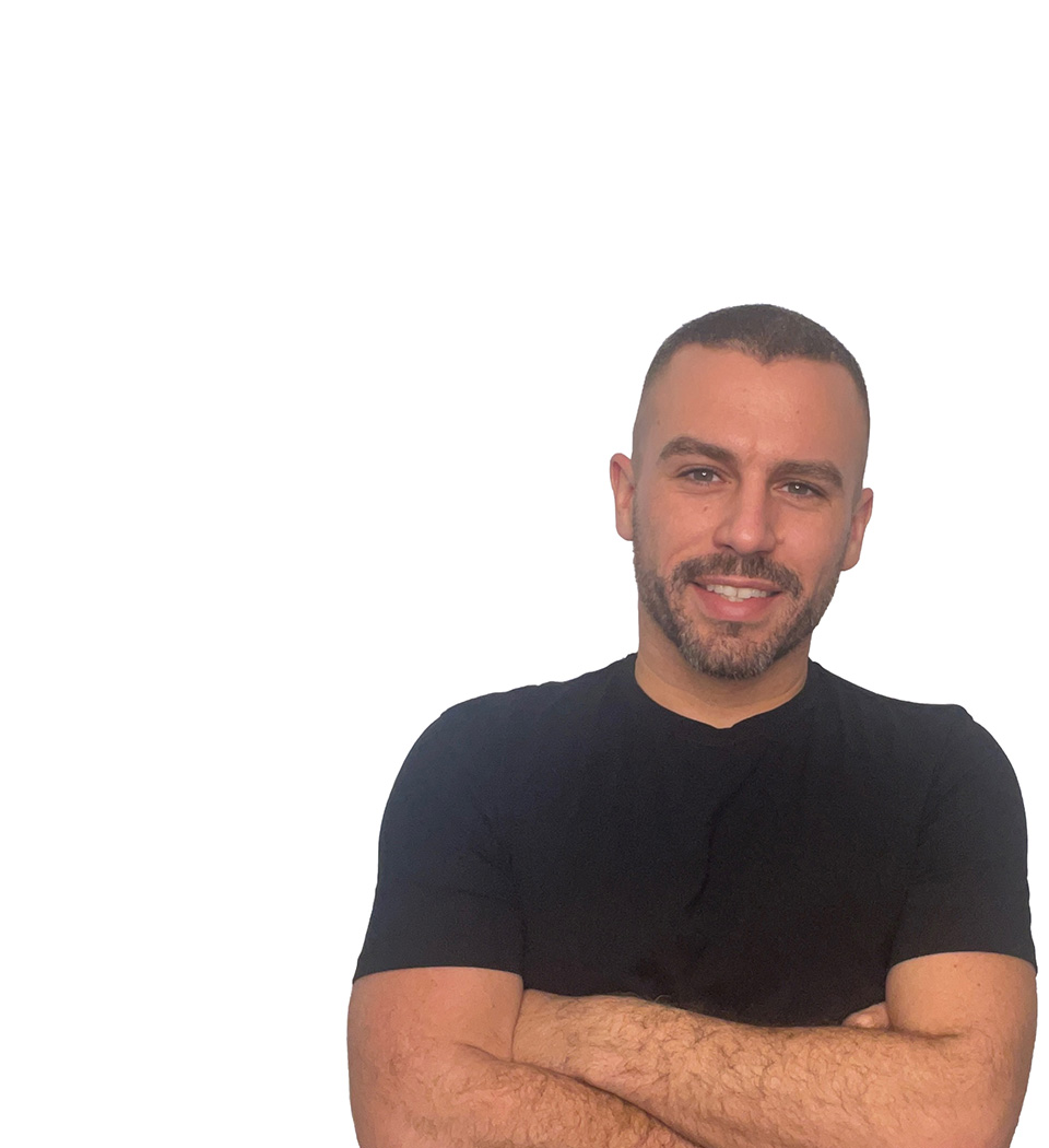 Barry’s instructor wearing a black top standing confidently smiling against a white background