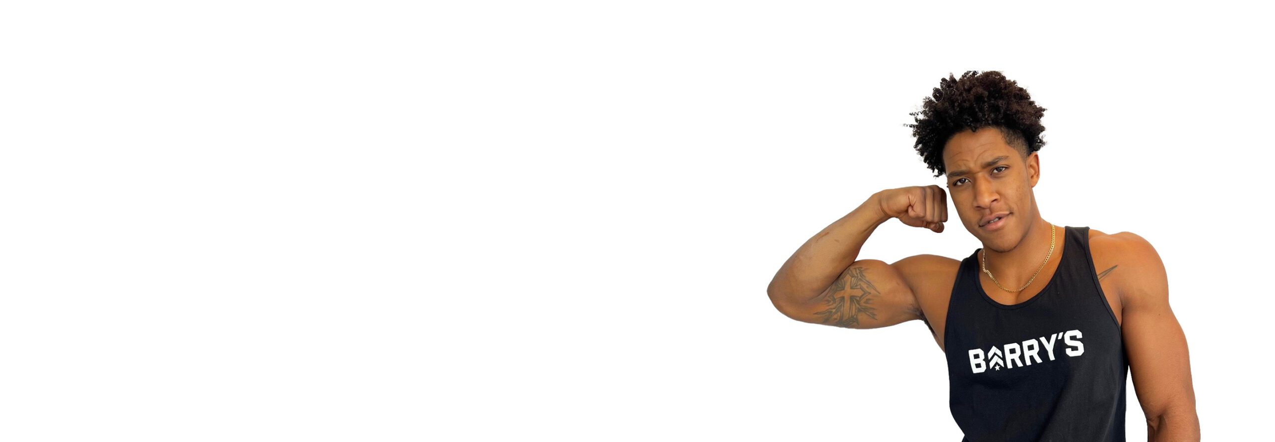Barry's instructor standing confidently flexing bicep wearing a black top against a white background.