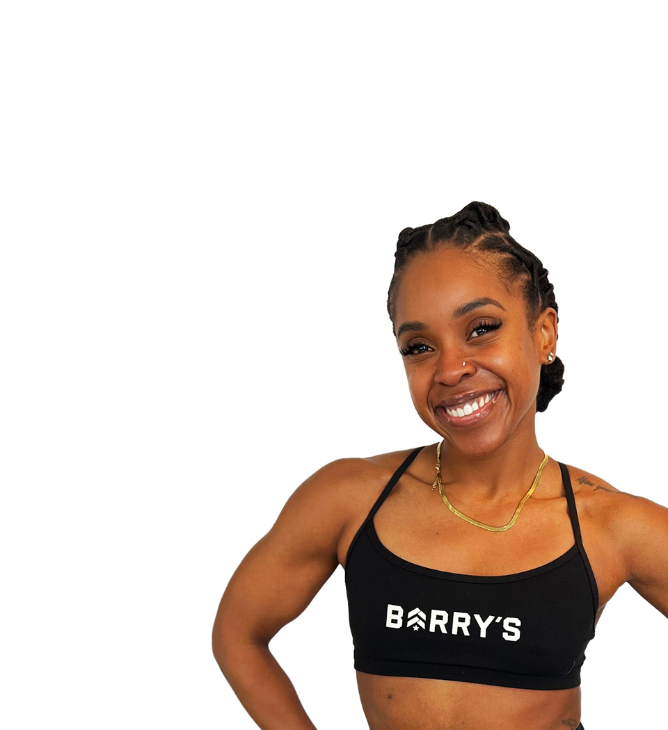 Barry's instructor standing confidently wearing a black top against a white background.