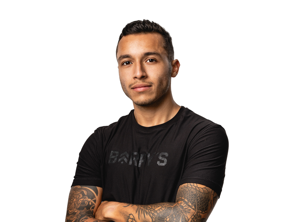 Barry's instructor standing confidently wearing a black top against a white background.