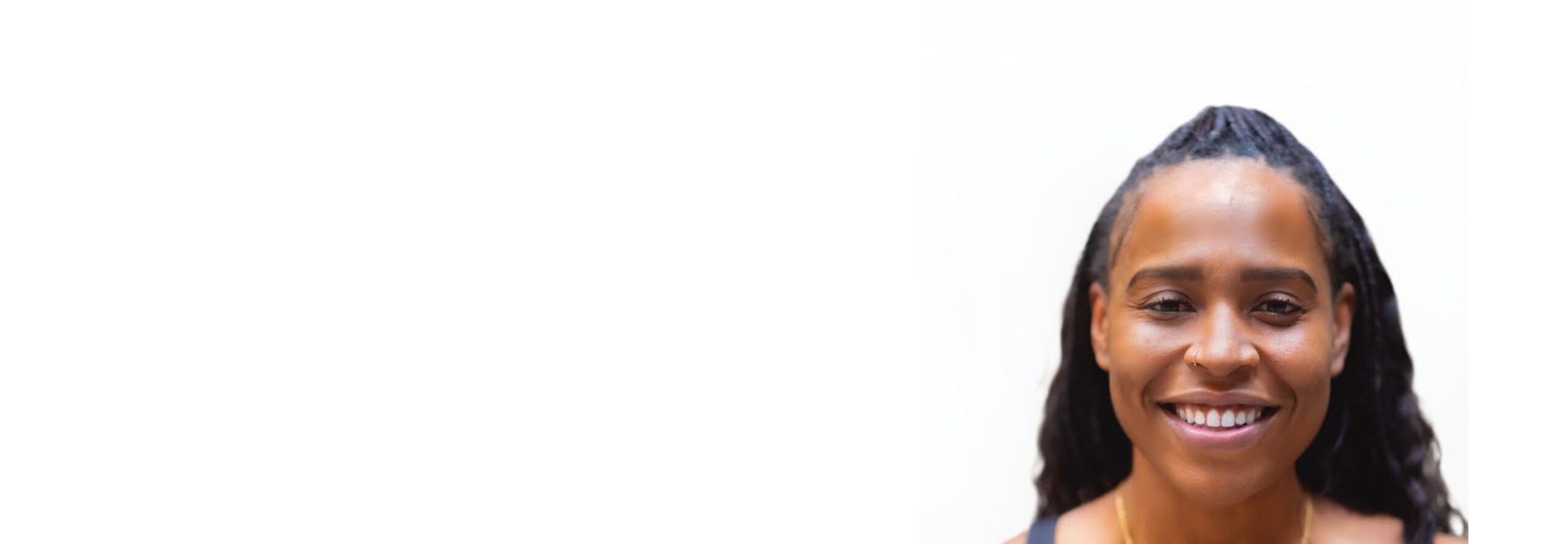 Barry's instructor standing confidently, wearing a black tank top against a white background, ready for the next workout challenge.