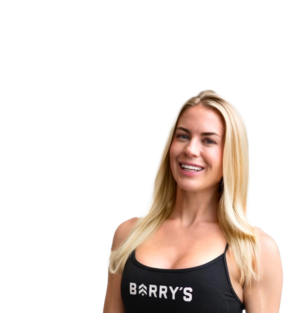 Barry's instructor standing confidently, wearing a black tank top against a white background, ready for the next workout challenge.