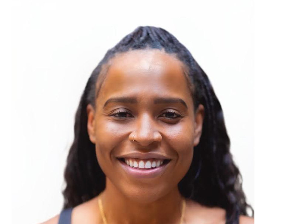 Barry's instructor standing confidently, wearing a black tank top against a white background, ready for the next workout challenge.