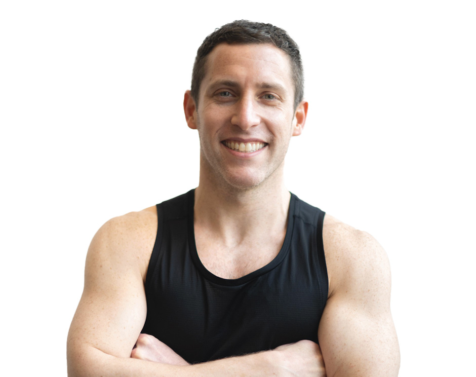 Barry's instructor standing confidently, wearing a black tank top against a white background, ready for the next workout challenge.