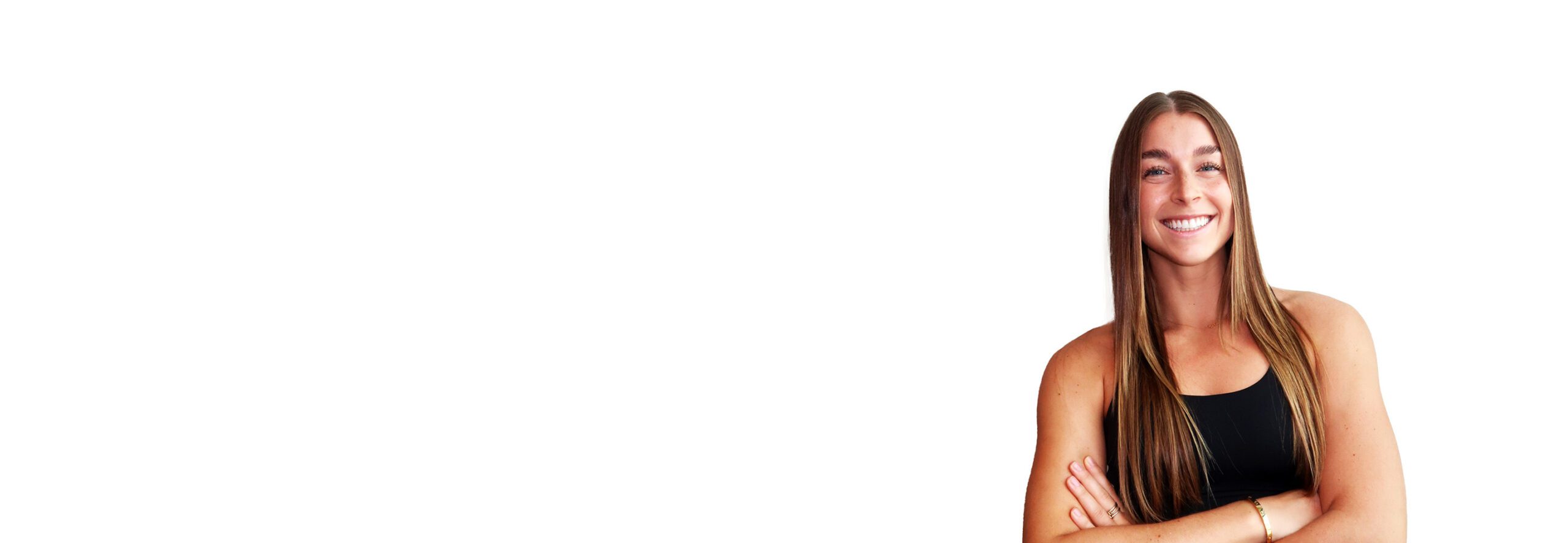 Barry’s instructor wearing a black top standing confidently smiling against a white background