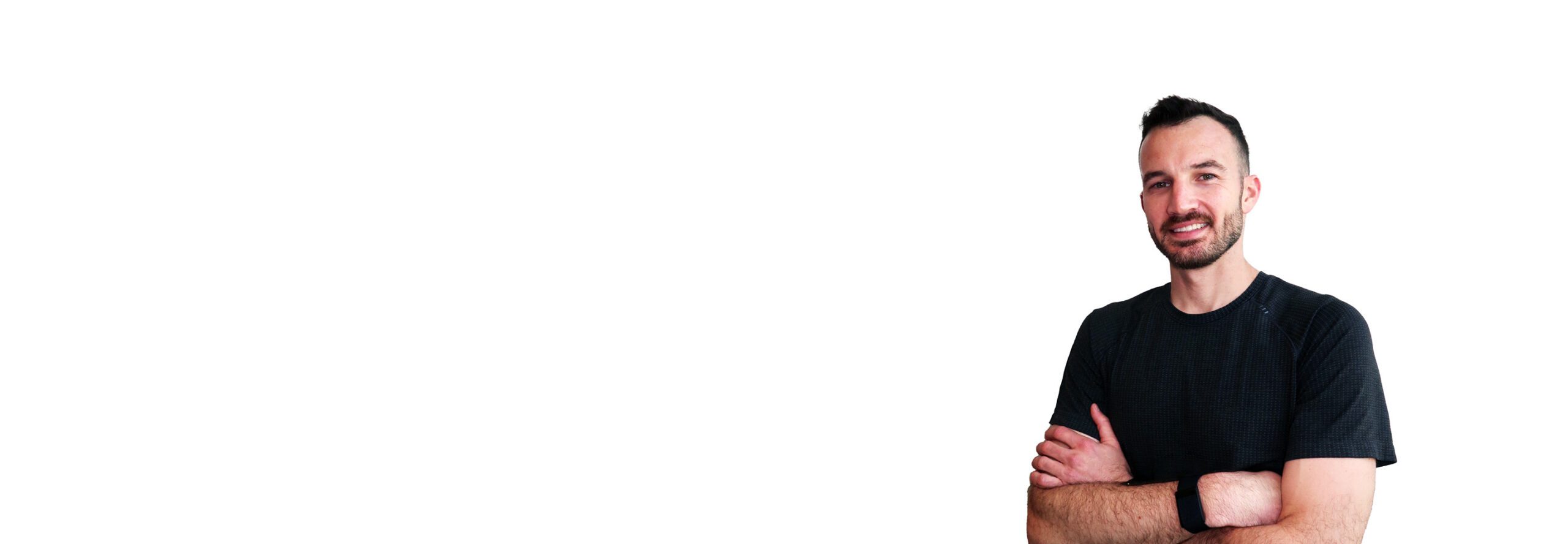 Barry’s instructor wearing a black top standing confidently smiling against a white background