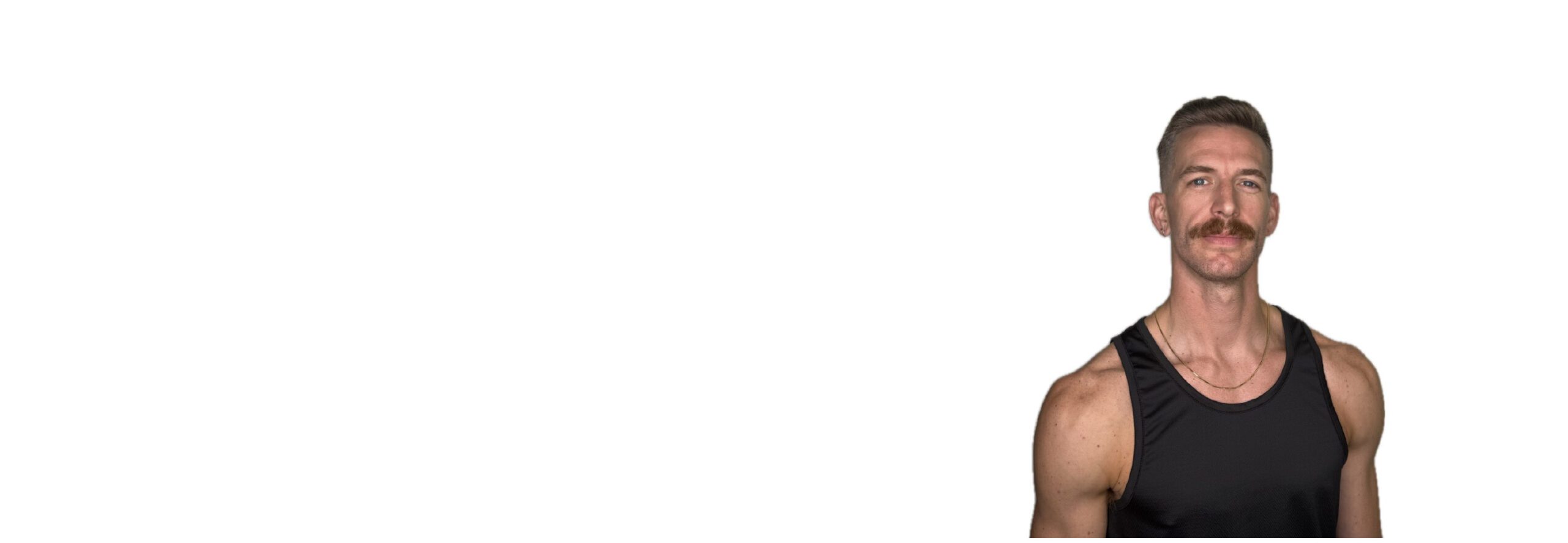 Barry’s instructor wearing a black top standing confidently smiling against a white background