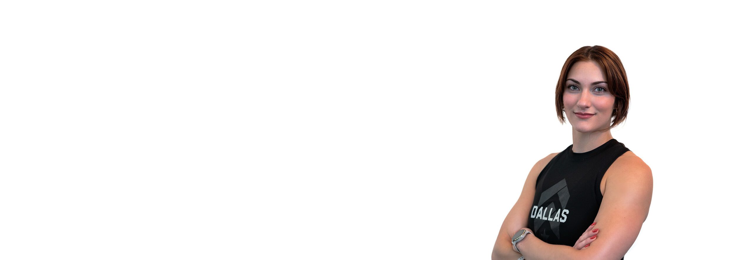 Barry’s instructor wearing a black top standing confidently smiling against a white background