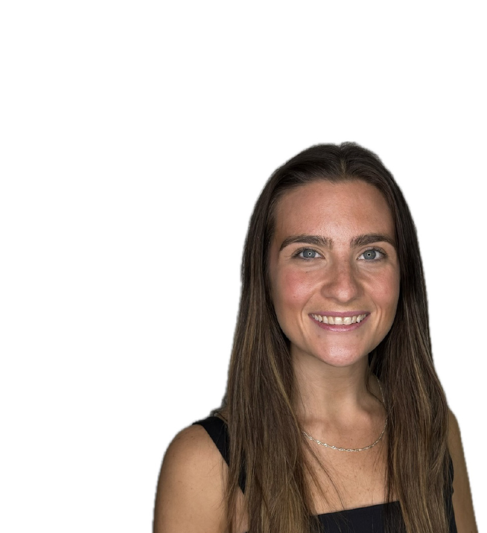 Barry’s instructor wearing a black top standing confidently smiling against a white background