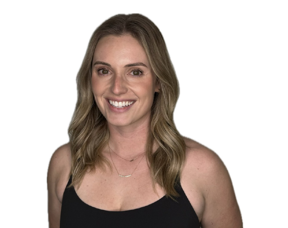 Barry’s instructor wearing a black top standing confidently smiling against a white background
